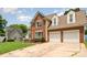 Charming two-story brick home with an attached garage and a well-manicured lawn at 8429 Meadowcroft Ct, Charlotte, NC 28215