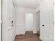 Welcoming foyer with wood-look flooring, white trim, and an open doorway to other rooms at 8429 Meadowcroft Ct, Charlotte, NC 28215