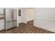 Kitchen view showing stainless steel refrigerator, and wood-look floors at 8429 Meadowcroft Ct, Charlotte, NC 28215