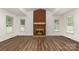 Bright living room with a brick fireplace and wood-look flooring at 8429 Meadowcroft Ct, Charlotte, NC 28215