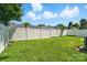 A spacious backyard with a well-maintained lawn, white fence, and ample space at 8605 Sawleaf Ct, Charlotte, NC 28215