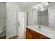 Bright bathroom featuring wood-look floors, a white vanity, and a large mirror over the sink at 8605 Sawleaf Ct, Charlotte, NC 28215