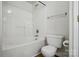 Bathroom with a combined bathtub and shower, and a standard toilet at 8605 Sawleaf Ct, Charlotte, NC 28215