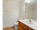 Bright bathroom featuring a vanity with sink, toilet, tub-shower combo and wood-look flooring at 8605 Sawleaf Ct, Charlotte, NC 28215