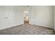 Bedroom featuring neutral walls, carpet, double doors, and an open doorway at 8605 Sawleaf Ct, Charlotte, NC 28215
