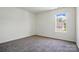 Bright bedroom featuring a window providing natural light and neutral carpeting at 8605 Sawleaf Ct, Charlotte, NC 28215
