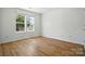Bright bedroom with wood floors, large windows, and neutral walls at 8605 Sawleaf Ct, Charlotte, NC 28215