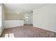 Large bonus room with neutral carpet, and natural light coming through the nearby window at 8605 Sawleaf Ct, Charlotte, NC 28215