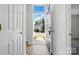 Bright foyer with wood-look flooring, a glimpse of the exterior, and an open doorway at 8605 Sawleaf Ct, Charlotte, NC 28215