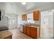 Bright kitchen featuring stainless steel appliances, wood cabinets, granite counters, and pass-through to the next room at 8605 Sawleaf Ct, Charlotte, NC 28215
