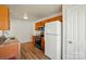 Efficient kitchen with stainless steel appliances, wood cabinets, and adjacent pantry at 8605 Sawleaf Ct, Charlotte, NC 28215
