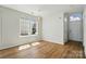 Bright living room with wood floors, a modern light fixture, and large windows at 8605 Sawleaf Ct, Charlotte, NC 28215