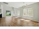 Spacious living room with abundant natural light, wood floors, and a sliding glass door to the backyard at 8605 Sawleaf Ct, Charlotte, NC 28215
