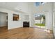 Open-concept living room with a fireplace, wood floors, and a sliding glass door to the backyard at 8605 Sawleaf Ct, Charlotte, NC 28215
