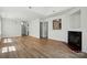 Spacious living room featuring wood floors, a fireplace, and an open layout at 8605 Sawleaf Ct, Charlotte, NC 28215