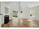 Bright and open living room with a fireplace, sliding glass door, and wood floors at 8605 Sawleaf Ct, Charlotte, NC 28215
