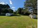 Large green backyard with outbuildings at 8827 Spring Meadow Dr, Hickory, NC 28601