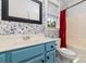 Bright bathroom with a charming blue vanity and colorful wallpaper at 939 White Point Dr, Huntersville, NC 28078