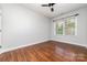 Well-lit bedroom featuring hardwood floors and a ceiling fan at 939 White Point Dr, Huntersville, NC 28078