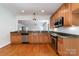 Open kitchen with granite countertops, stainless steel appliances, and natural wood cabinets at 939 White Point Dr, Huntersville, NC 28078