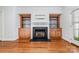 Living room featuring hardwood floors, built-in shelves, a fireplace, and a large window at 939 White Point Dr, Huntersville, NC 28078