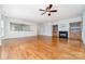 Spacious living room with hardwood floors, fireplace, custom shelving, and an open floor plan at 939 White Point Dr, Huntersville, NC 28078