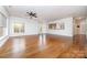 Expansive living room with hardwood floors, a ceiling fan, and open to the kitchen and entryway at 939 White Point Dr, Huntersville, NC 28078
