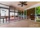 Inviting screened porch featuring a ceiling fan and views of the fenced backyard at 939 White Point Dr, Huntersville, NC 28078