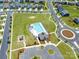 Aerial view of neighborhood pool and playground surrounded by homes and green spaces on a sunny day at 1004 Earlston Rd, Indian Trail, NC 28079