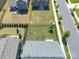 Aerial view showcasing the backyard with lush green grass, black metal fence, and surrounding residential properties at 1004 Earlston Rd, Indian Trail, NC 28079