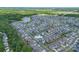Aerial view of a neighborhood nestled among lush greenery, featuring winding roads and a serene lake at 1004 Earlston Rd, Indian Trail, NC 28079