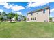 Spacious backyard featuring lush green grass, a black metal fence, and views of neighboring homes at 1004 Earlston Rd, Indian Trail, NC 28079