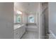 Bright bathroom with double vanity, garden tub, and tiled shower with glass door at 1004 Earlston Rd, Indian Trail, NC 28079