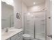 Clean bathroom featuring a glass-enclosed shower, white vanity, modern fixtures, and tiled floors at 1004 Earlston Rd, Indian Trail, NC 28079
