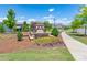 Entrance sign with stone base, pergola, and flowerbed, enhancing community appeal with landscaping at 1004 Earlston Rd, Indian Trail, NC 28079