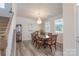 Formal dining room with wood floors, modern chandelier, and lots of natural light at 1004 Earlston Rd, Indian Trail, NC 28079