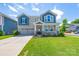 Charming two-story home featuring a welcoming front porch and a well-manicured lawn at 1004 Earlston Rd, Indian Trail, NC 28079
