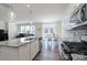 Open-concept kitchen with granite counters and a breakfast nook, flowing into the living area at 1004 Earlston Rd, Indian Trail, NC 28079