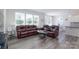 Bright living room features a comfortable leather sectional sofa and plenty of natural light at 1004 Earlston Rd, Indian Trail, NC 28079