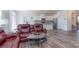 Open-concept living room with gray floors, comfortable seating, and a view of the modern kitchen at 1004 Earlston Rd, Indian Trail, NC 28079