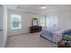 Main bedroom features a tray ceiling, lots of light from windows, and neutral decor at 1004 Earlston Rd, Indian Trail, NC 28079