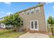 Back exterior with patio, manicured lawn, french doors and view of the home's backyard at 1020 Bannister Rd, Waxhaw, NC 28173