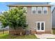 Well-kept backyard with patio, lush tree, and view of the home's rear exterior at 1020 Bannister Rd, Waxhaw, NC 28173