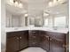 Bathroom features double sinks, cherry vanity cabinets, large mirror and a shower at 1020 Bannister Rd, Waxhaw, NC 28173