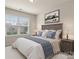 Bedroom with neutral walls, carpet, a Queen bed, and a large window with natural light at 1020 Bannister Rd, Waxhaw, NC 28173