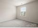 Bedroom with neutral walls and carpet, featuring a large window at 1020 Bannister Rd, Waxhaw, NC 28173