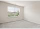 Bright bedroom with a large window, neutral carpet and a view of the outdoors at 1020 Bannister Rd, Waxhaw, NC 28173