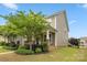 Side view of a two-story home showcasing manicured landscaping, vinyl siding, and stone accents at 1020 Bannister Rd, Waxhaw, NC 28173