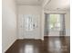 Bright foyer featuring dark hardwood floors, decorative glass door, and lots of natural light at 1020 Bannister Rd, Waxhaw, NC 28173