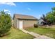 Side view of detached garage with white door and well-maintained landscaping at 1020 Bannister Rd, Waxhaw, NC 28173